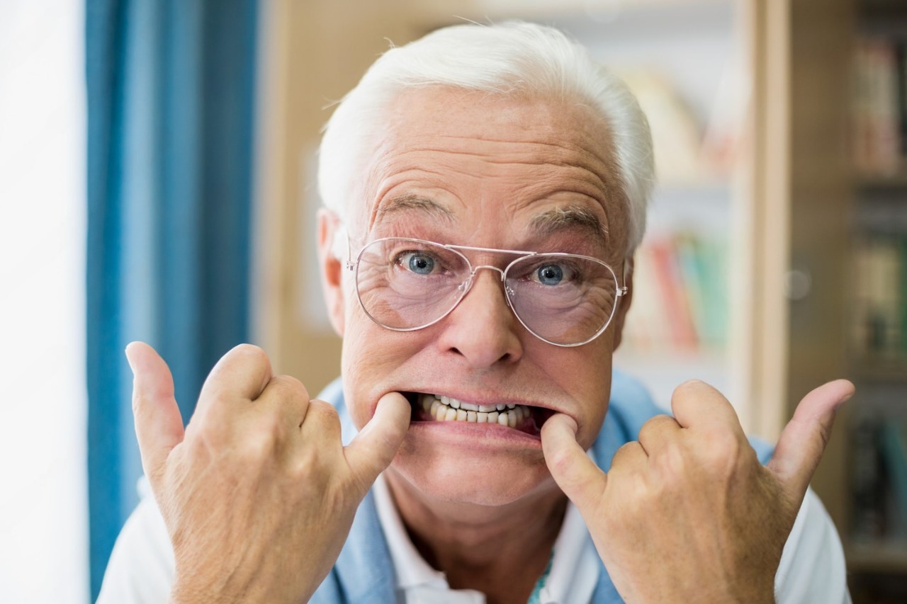 Senior man playfully showing his teeth and making funny faces, emphasizing the importance of oral health and preventive dentistry at Laguna Niguel Dental clinic.
