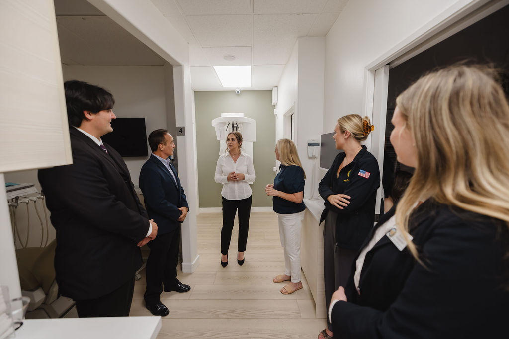 Cake cutting moment at the Laguna Niguel Dental grand opening with Dr. Ashtiany and her team