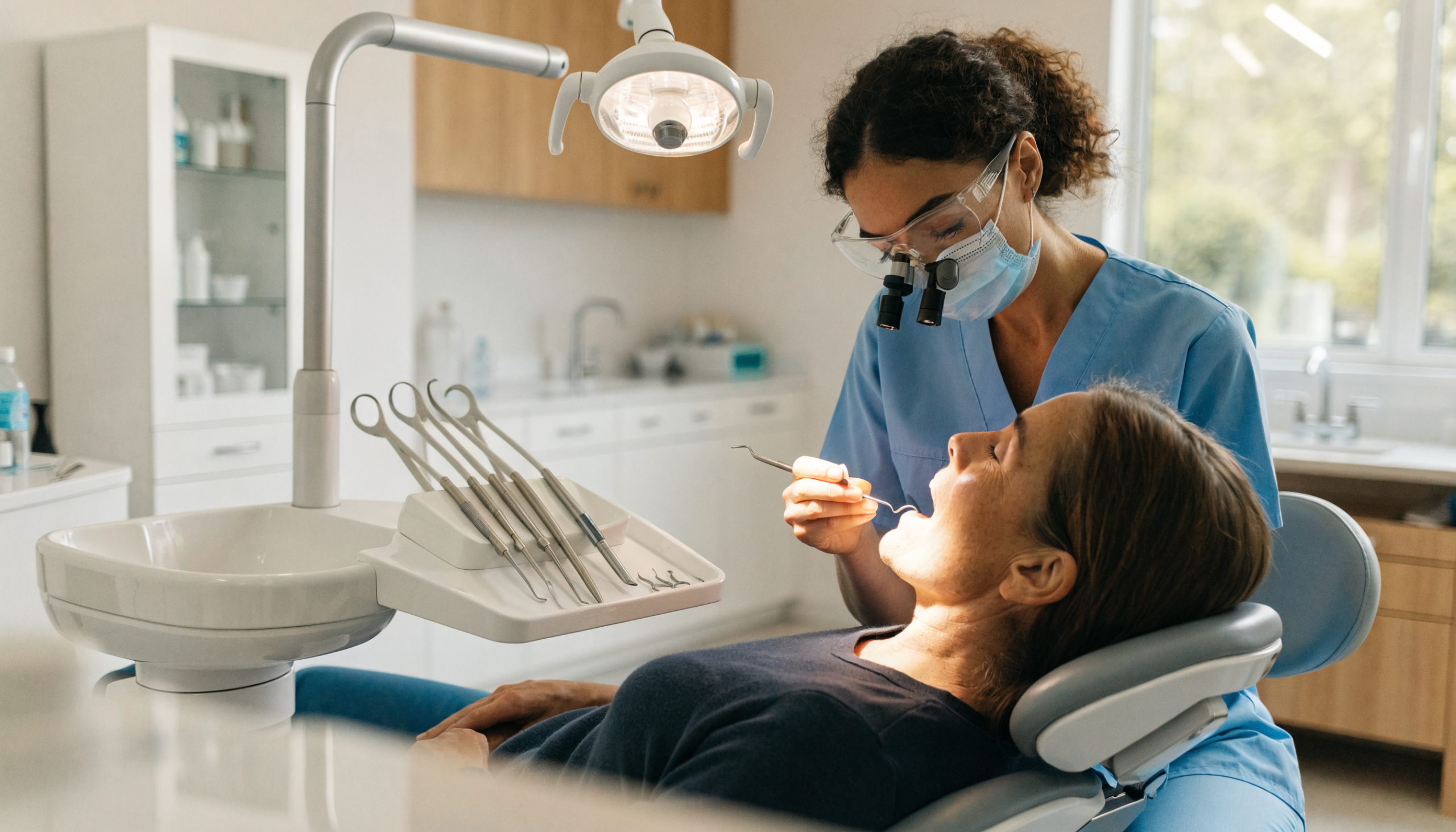 Dentist performing a gentle tooth extraction in Laguna Niguel on a comfortable, relaxed patient at Laguna Niguel Dental