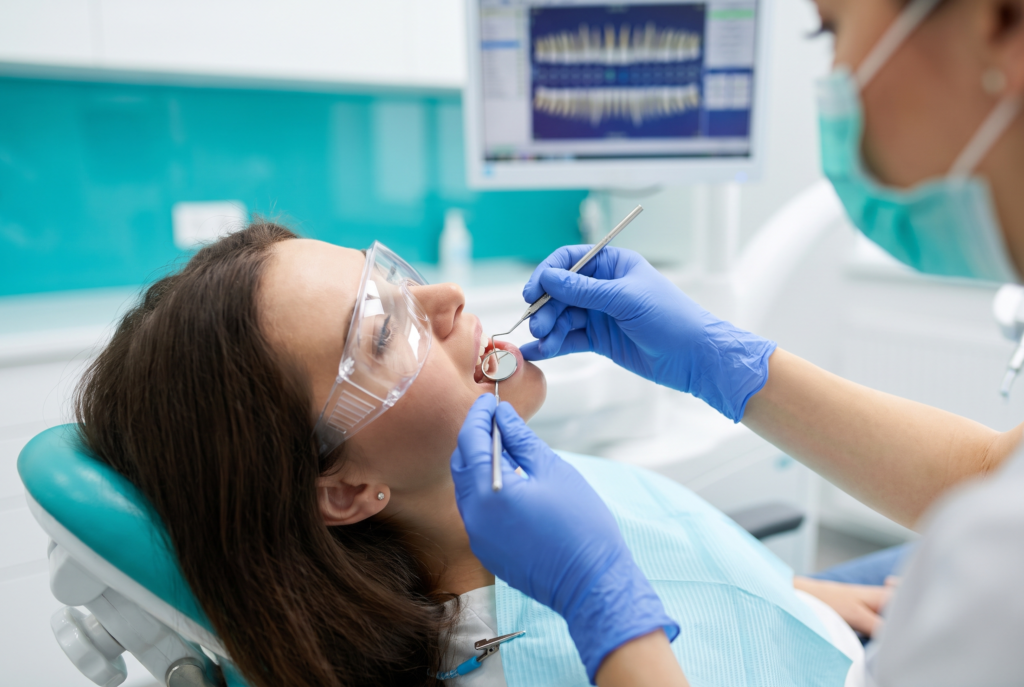 Hygienist measuring gum pocket depth with a periodontal probe during a gum health check